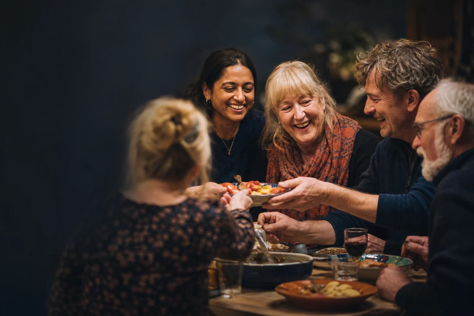 Friends sharing food and conversation at a community gathering